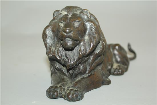 A patinated bronze model of a recumbent lion, 9in.